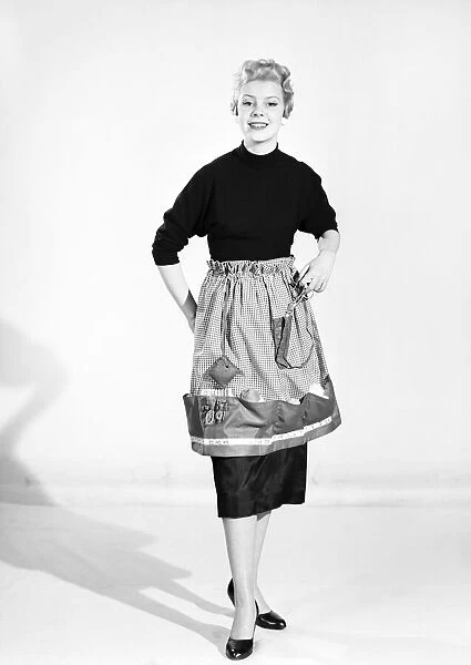 Woman wearing Dutch apron that converts into a bag. 1955