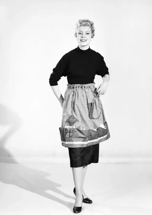 Framed Print : Woman wearing Dutch apron that converts into a bag. 1955 Framed Print : Woman wearing Dutch apron that converts into a bag. 1955