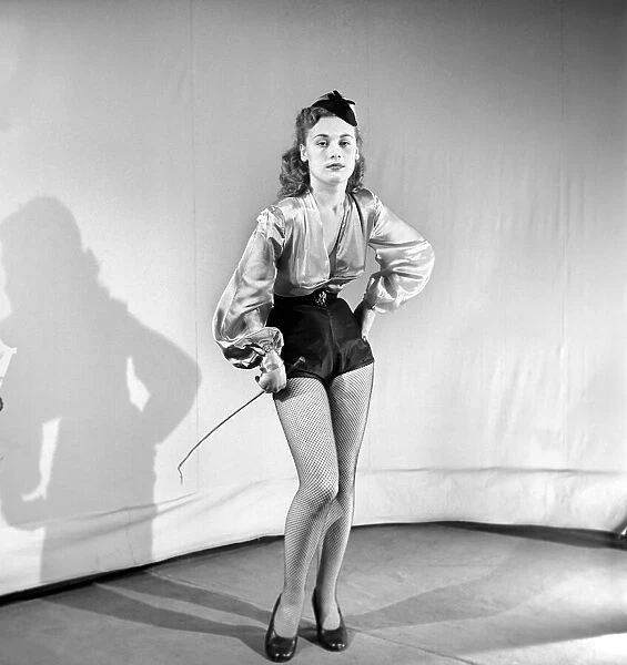 Woman wearing fancy dress jockey outfit. 1959