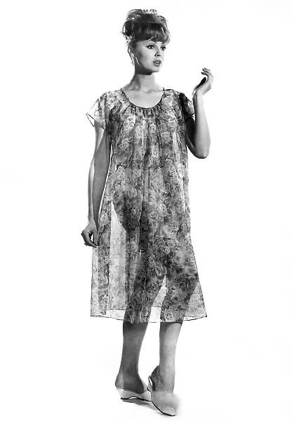 Woman wearing flowered nightdress. Reveille Fashions. Yvette Davies. April 1962 P008845