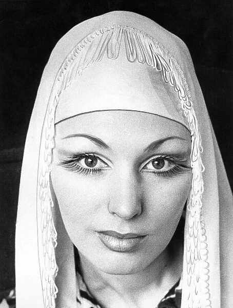 A woman wearing long false eye lashes