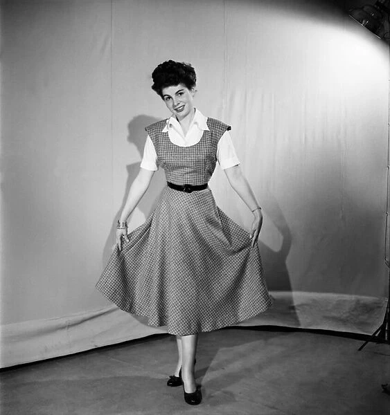 Woman wearing a pinafore dress November 1952 C6272-001
