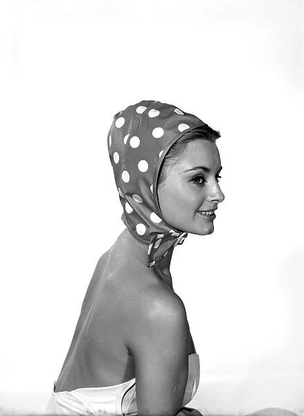 Woman wearing a polka dot hat hood. 1959