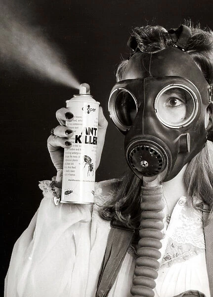 A woman wearing a protective gas mask - February 1981 holding