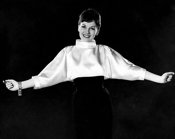 Woman wearing silk white shirt with black skirt. Reveille Fashions. Diana Lovell