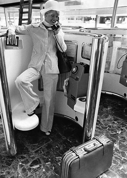 Woman wearing a suit talking on the telephone. May 1973 P008442