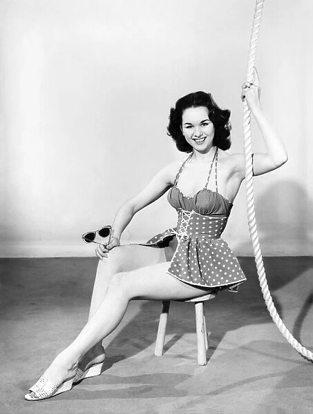 Woman wearing swimming costume. 1955