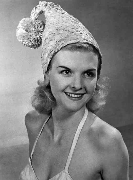 Framed Print : Woman wearing an unusual hat and bikini top April 1953 P017643