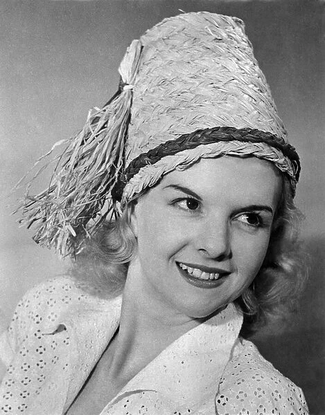 Woman wearing an unusual straw hat April 1953 P017642