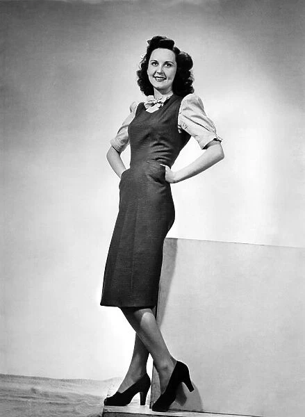 Woman wearing wartime fashions, a long sleeveless dress. March 1943 P010262