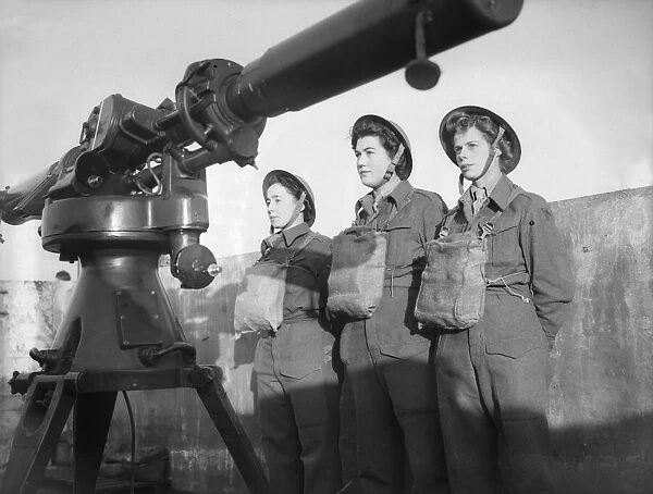 Women of the ATS operating the height finder optics at an anti aircraft battery in