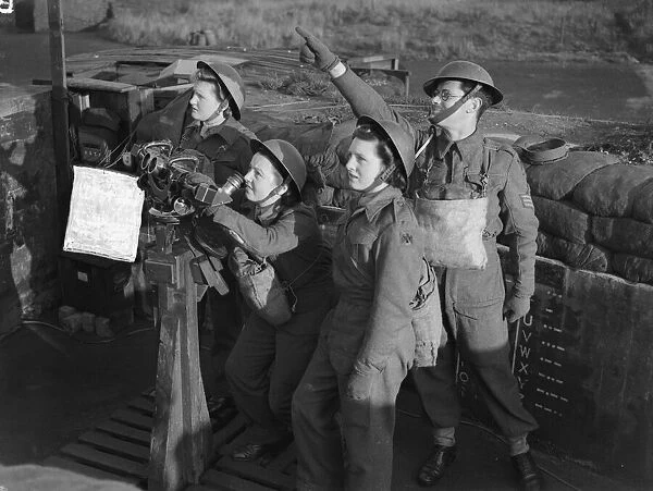 Women of the ATS operating a identification telescope at an anti aircraft battery in