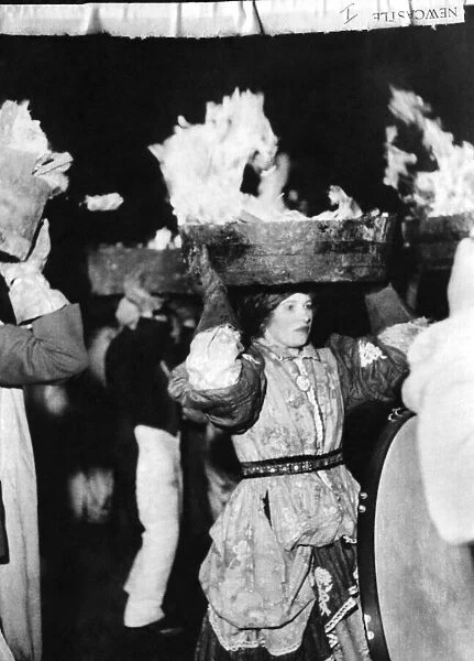 Women balancing barrels of burning tar upon their heads during the Pagan New year
