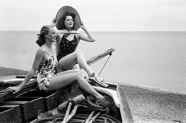 Women in their bathing costumes in a fishing boat along the coast, Hastings, circa 1945
