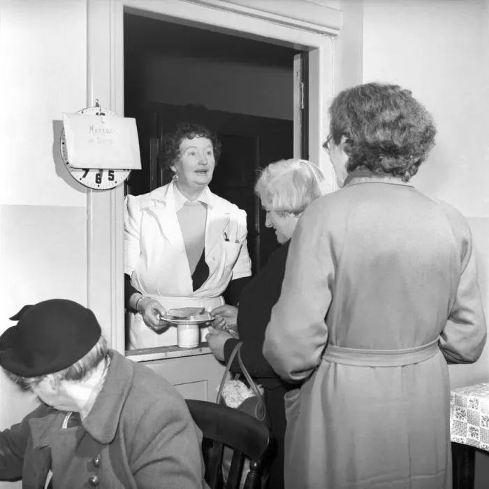 Framed Print : Women chat, share a cup of tea and read the newspapers at a womens lodging house