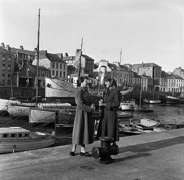 Two women chatting by the Quayside in Douglas, Isle of Man. 13th May 1954