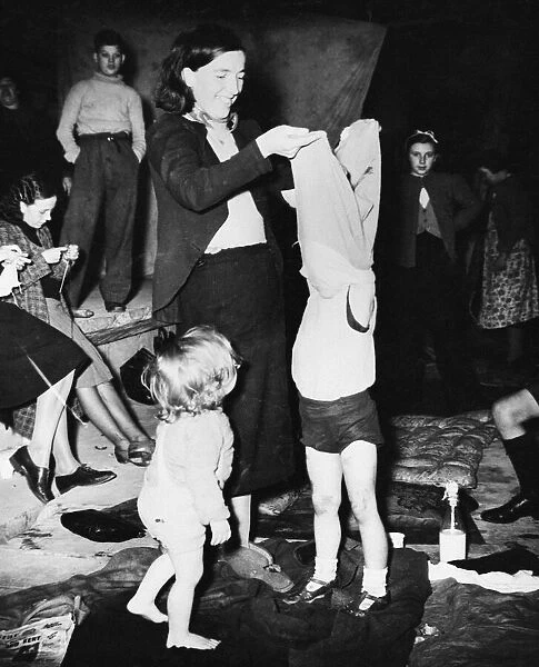 Women and children prepare to sleep in a bomb shelter during Second World War