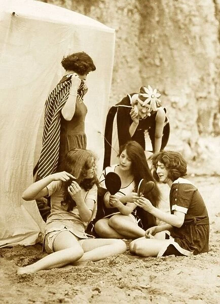 Women combing their hair and drying off after a swim in the sea Circa 1910