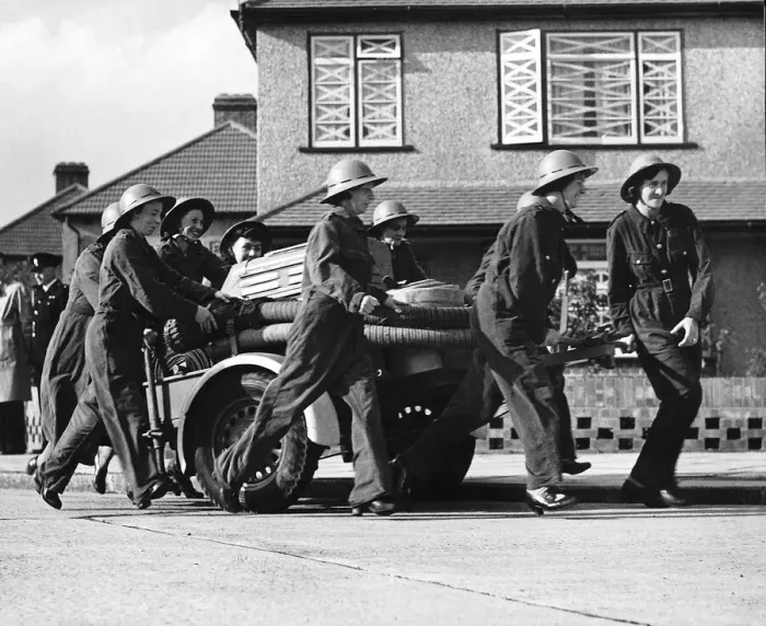 Framed Print : Women fire fighters from Erith Kent walk beside their trailer pump during WW2 1942