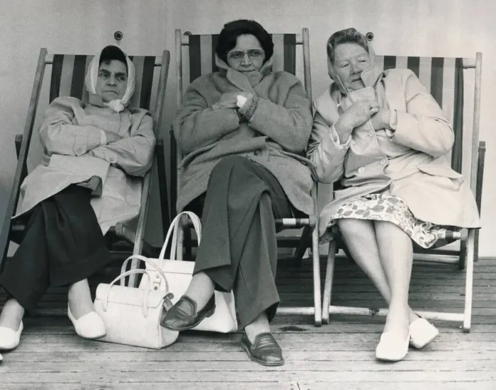 Framed Print : Three women Holidaymakers are all wrapped up in coats and scarves as they fight off Framed Print : Three women Holidaymakers are all wrapped up in coats and scarves as they fight off