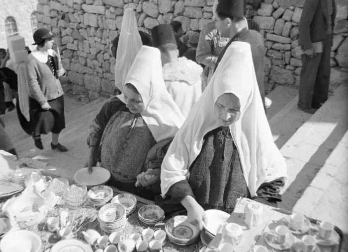 Framed Print : Women inspects crockery in the market in Bethlehem Circa 1935