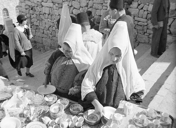 Women inspects crockery in the market in Bethlehem Circa 1935