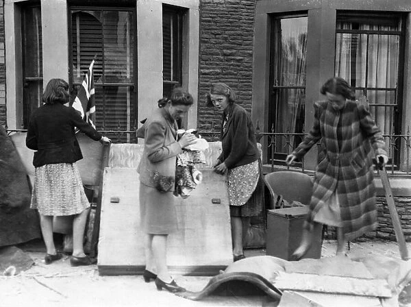 Women look through belongings from their homes after an air raid bombing. Cardiff, Wales