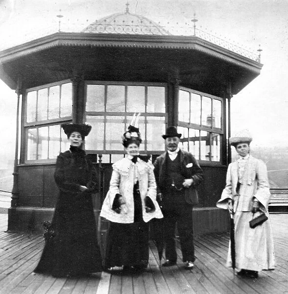 Women and men wearing edwardian fashion during a trip to the seaside at Roker Beach circa