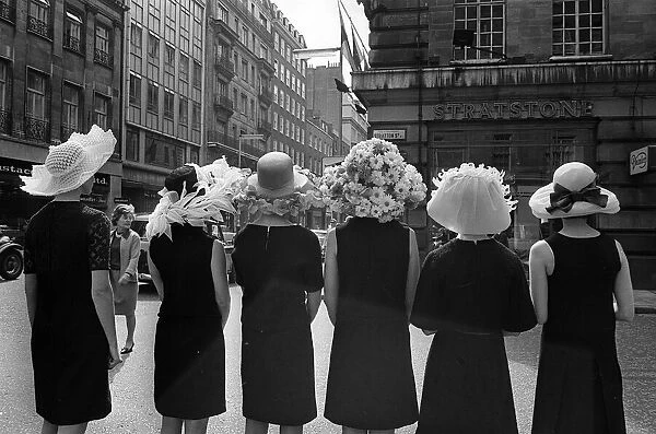 Women modelling hats for the 1966 Royal Ascot festiva - back view of the floral hatsl