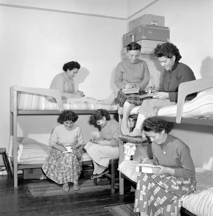 Framed Print : Women mushroom pickers from overseas seen here after work writing letters. 1963