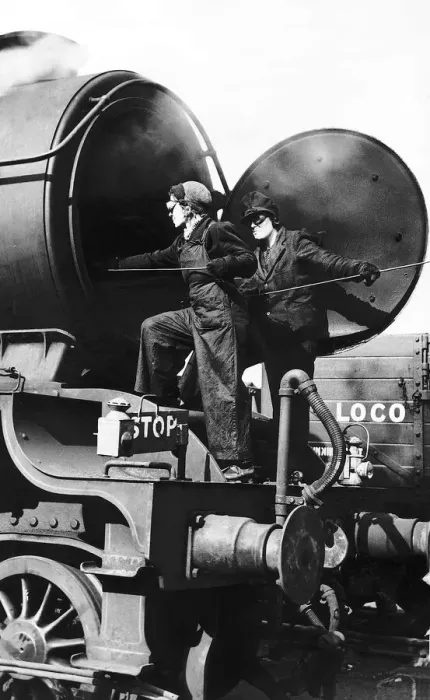 Framed Print : Women railway workers clean out a steam engine boiler during WW2. 1942