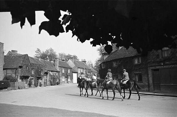 Women riding on horses down Village Road, Denham, Buckinghamshire. Circa 1945