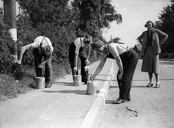 Women Road Painters, 1941 Women painting the kerb white so it can be seen during