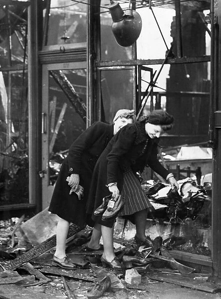 Two women salvaging the stock after their shop had been burnt out buy incendiary bombs