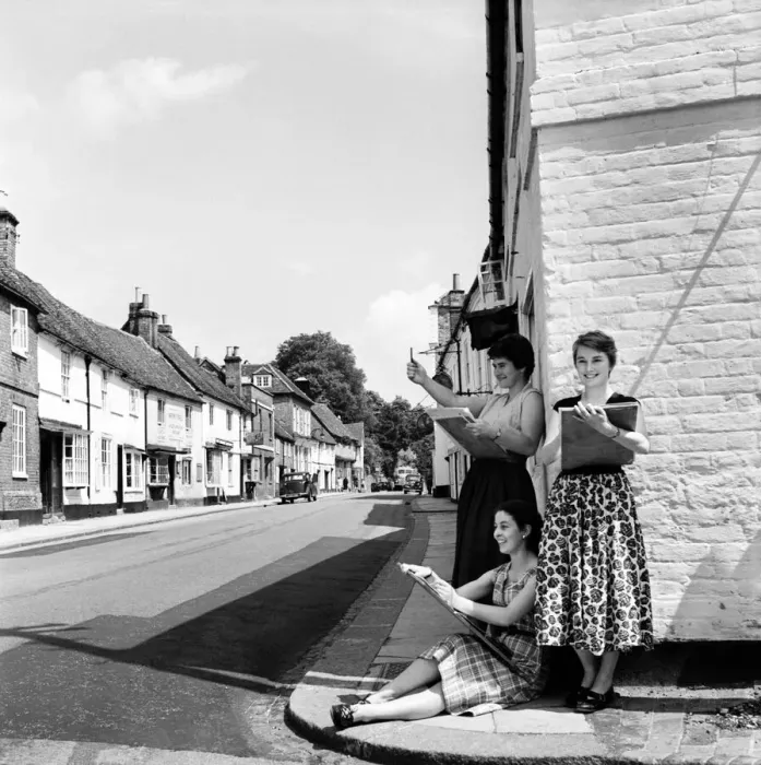 Framed Print : Women of West Wycombe in Buckinghamshire standing in the street making sketches of local