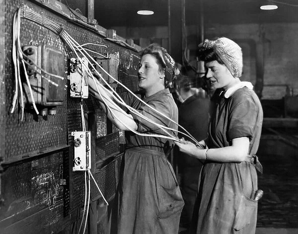 Women wiring up warship which nears completion in a Scottish Shipyard