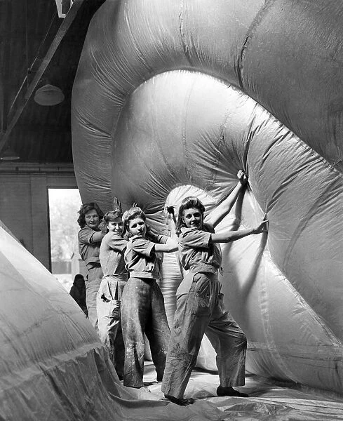 Women working in a barrage balloon factory haul a section into position. WW2 1943