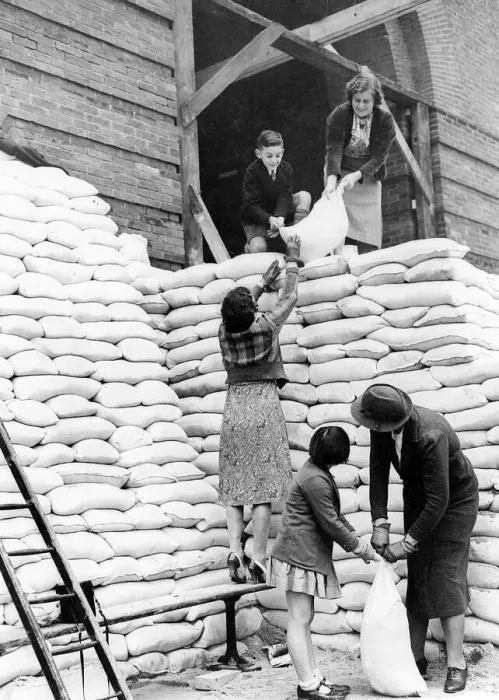 Framed Print : Women during WW2 - 1939 Parents and children help to sandbag the main entrance to Framed Print : Women during WW2 - 1939 Parents and children help to sandbag the main entrance to