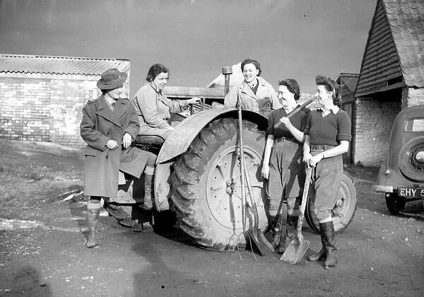 Womens Land Army girls with a tractor probably taken on farms in North Somerset