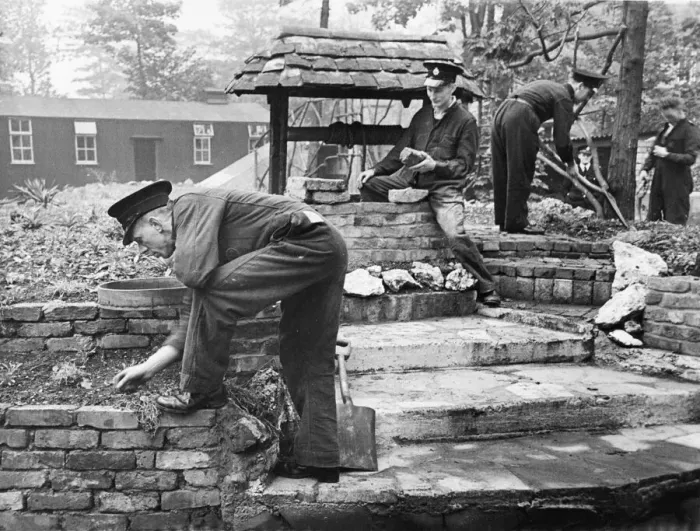Framed Print : Work begin done on a rockery, under the instruction of Fireman C A Bull