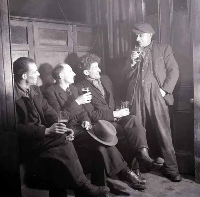 Framed Print : Work mates sit in the snug and enjoy a cigarette and a pint of beer following a hard days