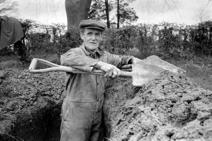 Framed Print : Is work wonderful?. Feature. Grave Digger at work in the grave yard of Windlesham Church Framed Print : Is work wonderful?. Feature. Grave Digger at work in the grave yard of Windlesham Church