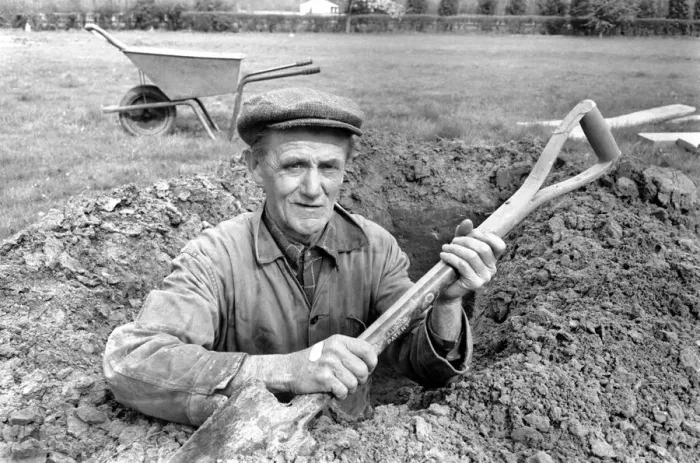Framed Print : Is work wonderful?. Feature. Grave Digger at work in the grave yard of Windlesham Church Framed Print : Is work wonderful?. Feature. Grave Digger at work in the grave yard of Windlesham Church