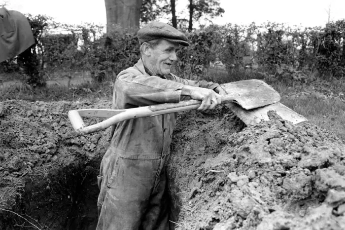 Framed Print : Is work wonderful?. Feature. Grave Digger at work in the grave yard of Windlesham Church Framed Print : Is work wonderful?. Feature. Grave Digger at work in the grave yard of Windlesham Church