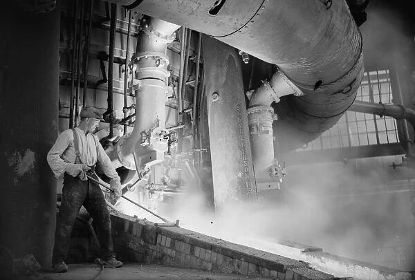 A worker checks the molten metal at the new one million pound furnace at Ford