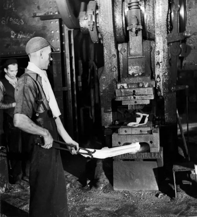 Framed Print : A worker holding his finished product, a drop-forged front axle Framed Print : A worker holding his finished product, a drop-forged front axle