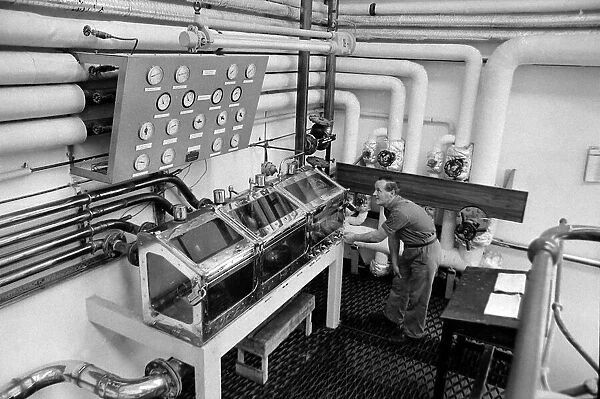 A worker inspects the Spirit safe at the Knockando Whisky Distillery January 1 972