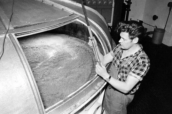 A worker at the Knockando Whisky Distillery checks the Washback January 1972