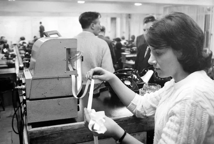 Framed Print : A worker at Ladbrokes betting shop watching the tape machine December 1967 Framed Print : A worker at Ladbrokes betting shop watching the tape machine December 1967