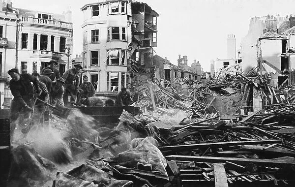 Workers clear rubble after an air raid during Second World War. 28th May 1943